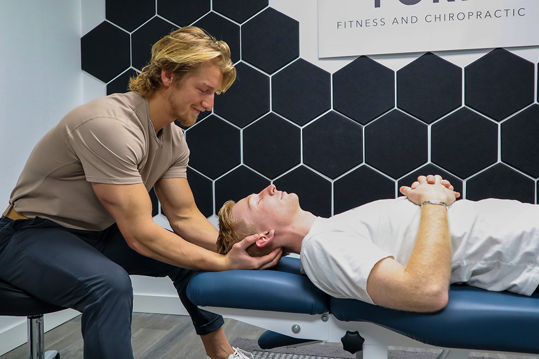 Patient being adjusted by Dr. Cutler at Form Fitness