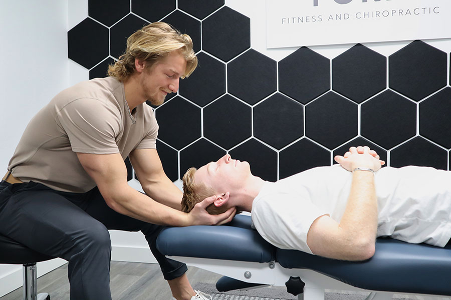 chiropractic doctor adjusting a male athlete